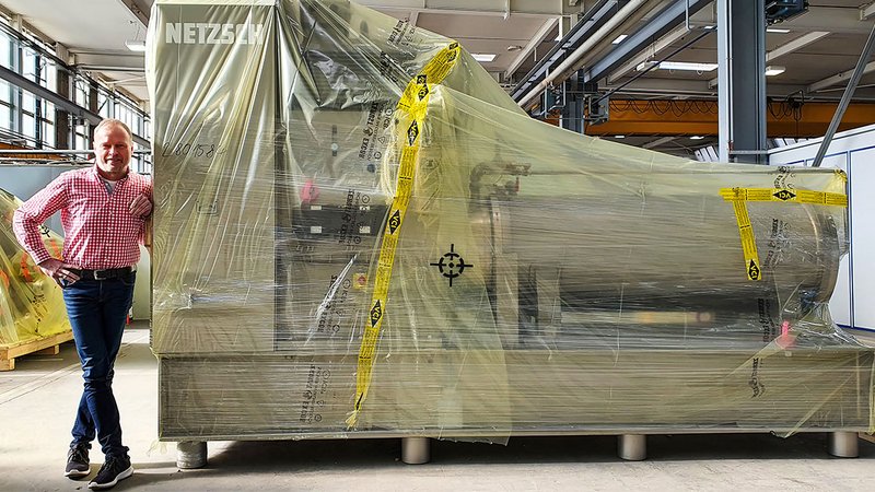 ICB-fóliába csomagolt gép. Mellette Hans-Jürgen Glettner, a selbi Netzsch-Feinmahltechnik GmbH üzemvezetője.
